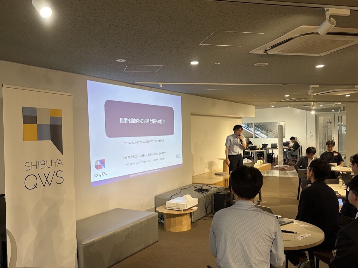 The technology overview and case study presentation. Dr. Takashi Isozaki, Senior Researcher at Sony CSL, is speaking.
